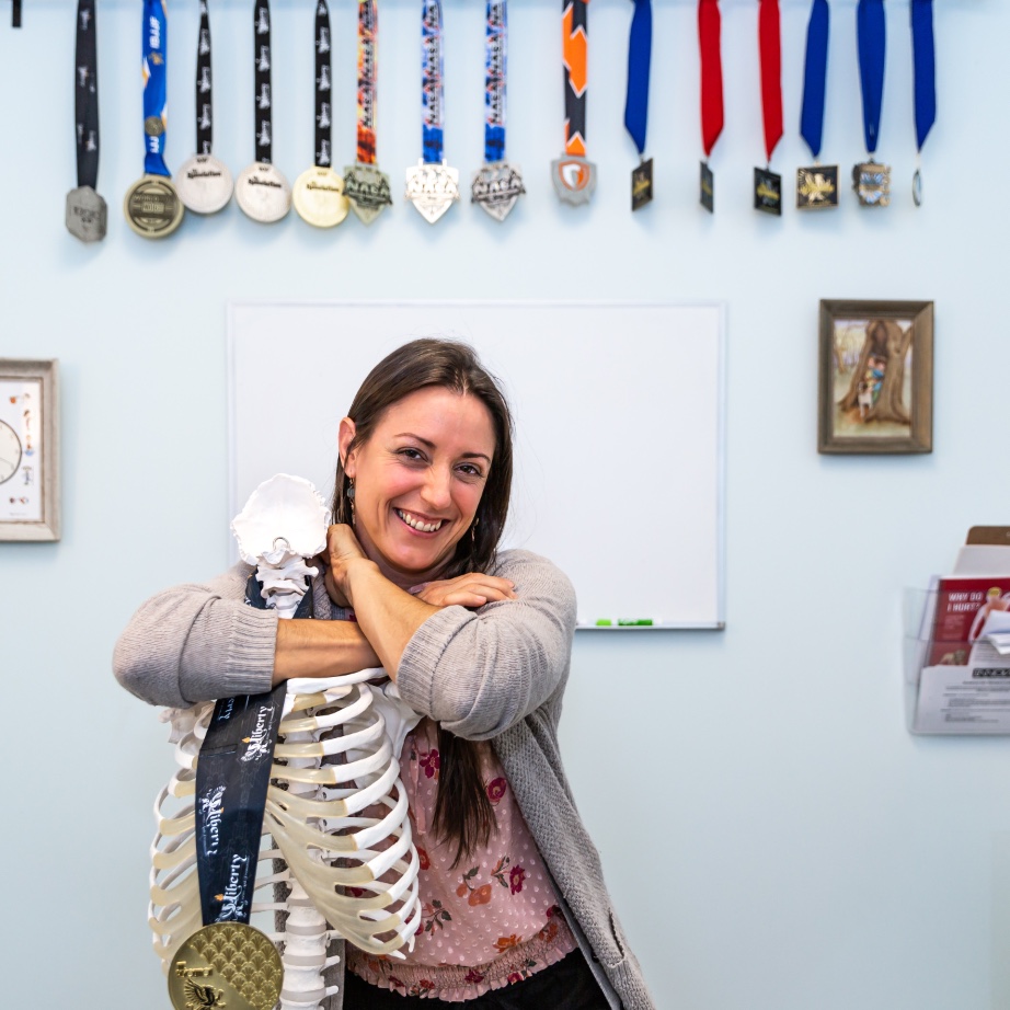 Katy stands with a model skeleton