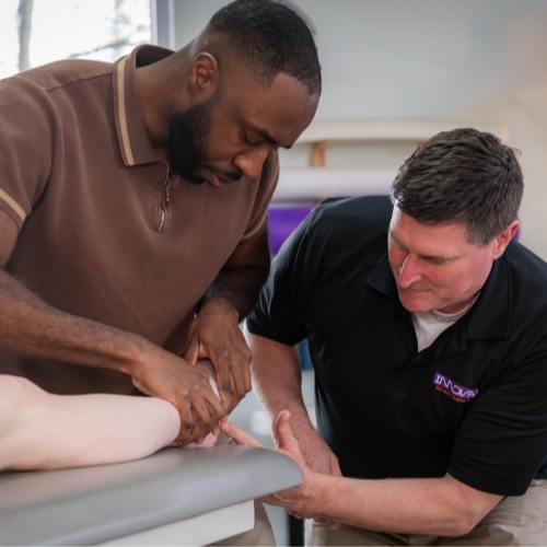 clinicians work with patient on a table